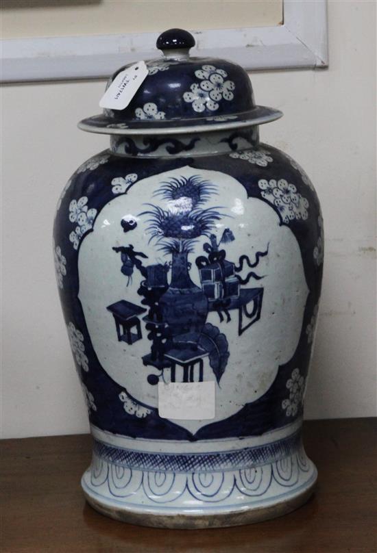 A pair of Chinese blue and white vases and covers decorated with prunus blossom